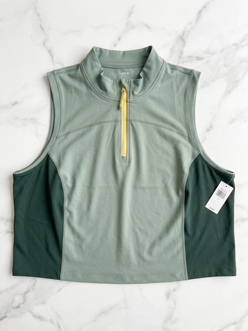 Old Navy Sage Green sleeveless zip tank with dark green panels and yellow zipper
